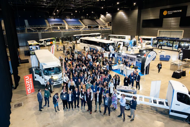 Delegates gathered on the expo floor at the Bus & Coach Association conference, with buses and coaches on display